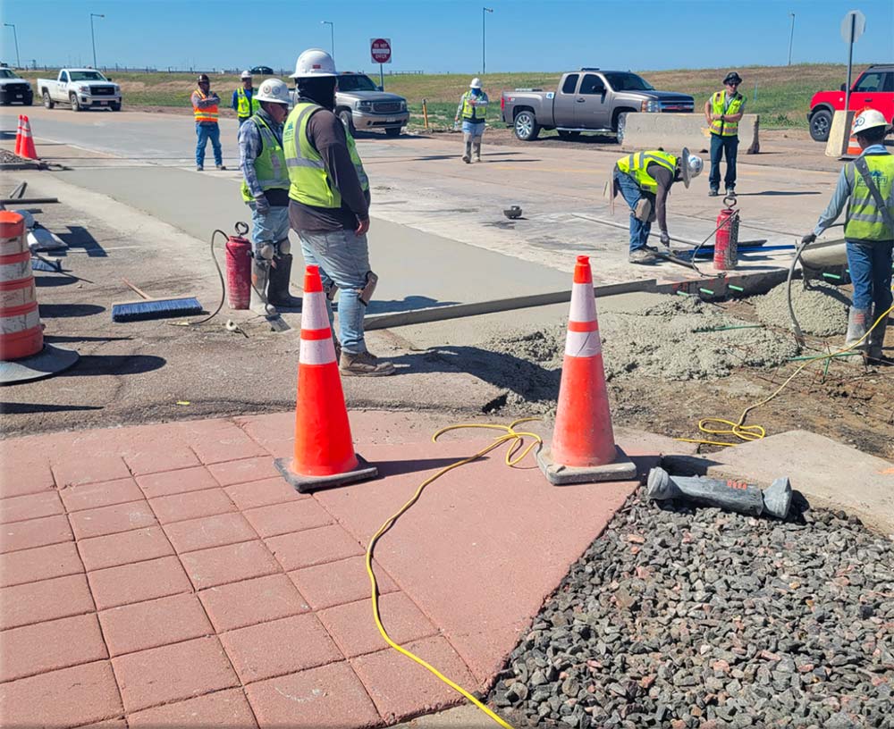 Panel rehab crews working through the day on Pena Boulevard 