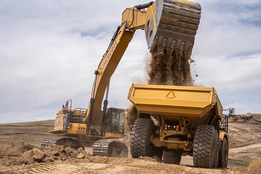 Excavator moving tons earth