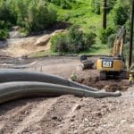 Securing sewer and water pipe into place at Jordanelle Reservoir for Jordanelle Special Service District